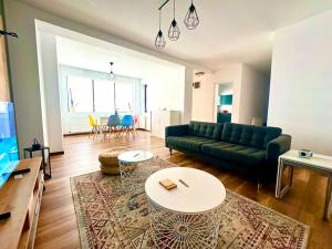 a living room with a couch and a table at Casa curte interioara, centru in Cluj-Napoca