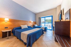 Postel nebo postele na pokoji v ubytování Hotel Rober Palas