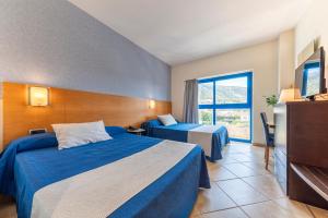 Postel nebo postele na pokoji v ubytování Hotel Rober Palas