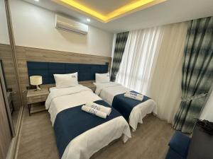 Кровать или кровати в номере Nurel Shark Residence