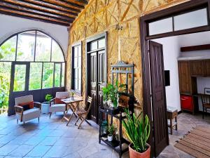 a large room with a table and chairs and windows at Flor Guest House in Yenişehir