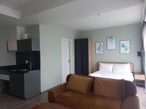 a living room with a couch and a bed at The Deck Patong 7Fl Mountain View 1 in Patong Beach