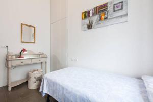 a white room with a bed and a sink at Apartamentos RG Arenal in Seville
