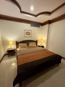 a bedroom with a large bed and two lamps at Serenity Shores - 2 King Bed - Beachfront Penthouse in Plai Laem +18 photos