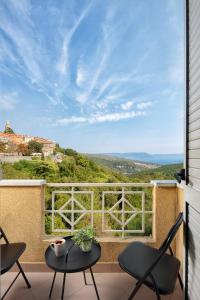 a view from a balcony with chairs and a table at Canova Apartment in Labin