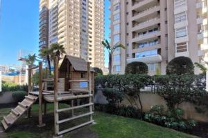 a tree house in a park with tall buildings at Depto Centro Viña in Viña del Mar