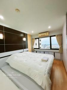 宋卡Panoramic View Suite的带窗户的房间里有一张白色的大床