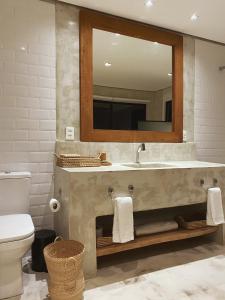 a bathroom with a sink and a mirror at Beach House Brazil in Amontada +9 photos