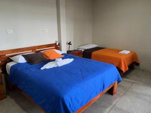 Voodi või voodid majutusasutuse Hostal Cattleya toas