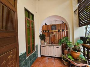 a room with an entry way with plants in it at HOME Penang in George Town