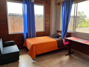 Voodi või voodid majutusasutuse Hostal Cattleya toas