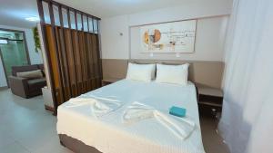 a bedroom with a bed with a towel on it at Flat FM20 Cabo Branco #L5 - By Almare in Tambaú +40 photos
