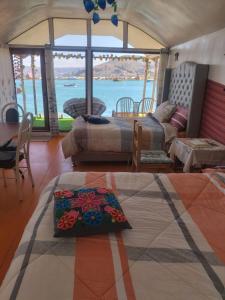 a living room with a view of the water at Titikaka sumaq tika lodge in Puno