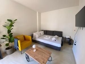 a room with a bed and a couch and a table at Blue Cozy Nest in Rhodes Town