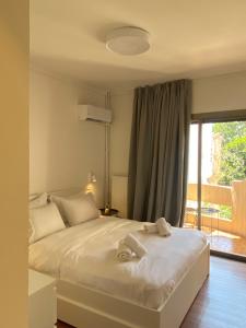 a bedroom with a bed with towels on it at Blue Cozy Nest in Rhodes Town