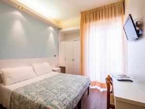 Postel nebo postele na pokoji v ubytování Hotel Sirena