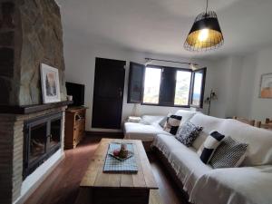 a living room with a couch and a fireplace at La Castaña y la Uva in Ohanes