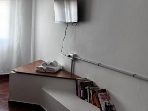 a stair railing with books and a book shelf at Corazón de la Ciudad Apart I in Villa María