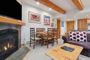 a living room with a couch and a fireplace at Lodge at Lionshead 110-100 in Vail
