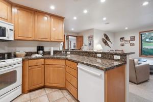 a kitchen with wooden cabinets and a counter top at Lodge at Lionshead 110-100 in Vail