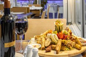 a plate of food on a table with a glass of wine at La Renaissance hôtel Marrakech in Marrakesh