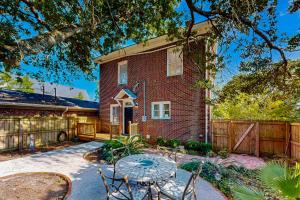 a brick house with a fence and a table and chairs at Historic Charmer in Wilmington