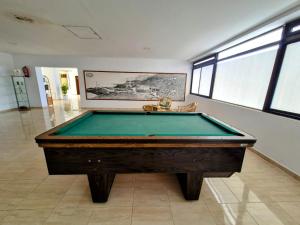 a pool table in a large room with at Arenas Negras Apartament Malaga in Puerto de Santiago