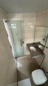 a bathroom with a toilet and a sink at Economy Master Hotel - Ji-Paraná in Ji-Paraná