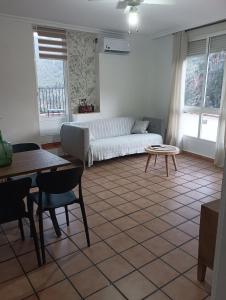a living room with a couch and a table at Los picarzos apartamento in Ayna