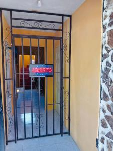 an open door with a sign in front of it at Hotel Las Lajas San José Pinula in San José Pinula