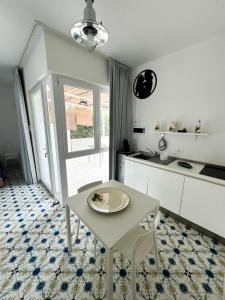 a kitchen with a table with a plate on it at Vento del Mar Tramontana in San Cataldo +27 photos