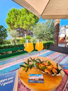 a plate of food and two glasses of orange juice at Apartment Milada in Banjol +22 photos