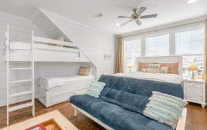 a bedroom with a couch and a bunk bed at Deja Blue by Oversee 30A in Santa Rosa Beach +118 photos