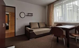 a living room with a couch and a table at Złota 24 in Karwia