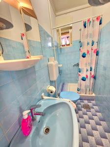 a bathroom with a sink and a toilet at Apartment Milada in Banjol