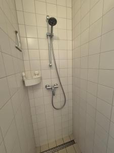 a shower with a shower head in a bathroom at Bij molen de Blazekop, rustig en landelijk in Ovezande +24 photos