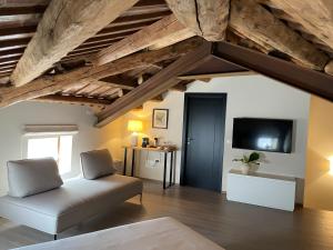 a living room with a couch and a tv at Palazzo Zurloni in Revine Lago