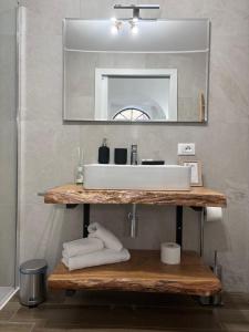 un baño con lavabo y espejo en Eccelsa 98, en Tívoli