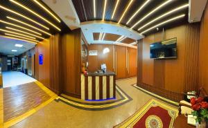 a lobby with a bar in the middle of a building at Al Ahrar Hotel in Dubai