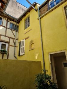 a yellow building with a door in front of it at Le Studio du Docteur Privey - Free & secure Park Bike -3mn Autoroute in Tournus