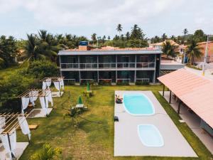 an aerial view of a resort with two swimming pools at Pousada Pé na Areia in São Miguel dos Milagres