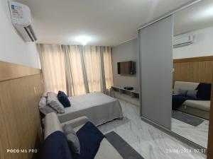 a hotel room with a bed and a mirror at Apto Praia Intermares Cabedelo Paraiba Q208 in Nossa Senhora do Livramento