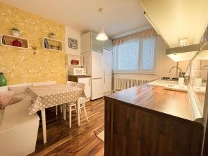 a kitchen with a table and a dining room at Villa Stella in Prešov