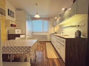 a kitchen with a table and a dining room at Villa Stella in Prešov