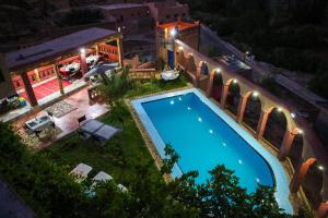 an overhead view of a swimming pool at night at Riad Gabsi Dades in Boumalne Dades