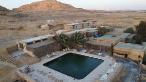 an aerial view of a swimming pool in the desert at Talist Siwa in Siwa