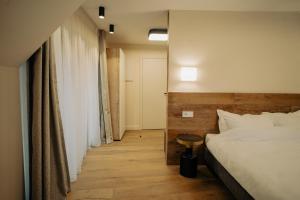 a hotel room with a bed and a table at Zen Den in Braşov