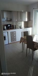 a kitchen with a table and a table and chairs at Villa incanto in Siculiana