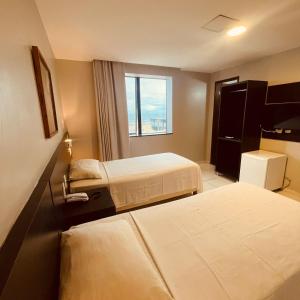 Postel nebo postele na pokoji v ubytování Absolutte Hotel