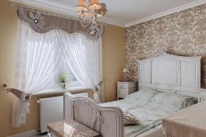 a bedroom with a white bed and a window at Holiday Home Ko czewo near Lakes and Forests in Kołczewo